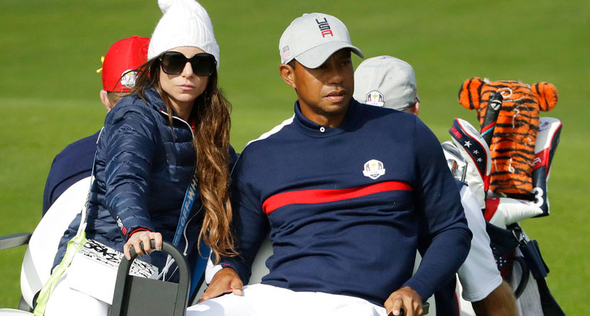 Tiger Woods of the US drives away in a buggy with his partner Erica Herman after his fourball match on the opening day of the 42nd Ryder Cup at Le Golf National in Saint-Quentin-en-Yvelines, outside Paris, France, Friday, Sept. 28, 2018. Woods and Patrick Reed lost to Europe's Francesco Molinari and Europe's Tommy Fleetwood.
