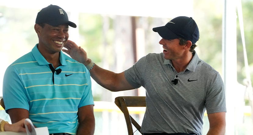 Golfers Tiger Woods, left, and Rory McIlroy share a laugh as they discuss the future home of their tech-infused golf league that will begin play next year, Tuesday, Feb. 21, 2023, on the campus of Palm Beach State College in Palm Beach Gardens, Fla. (AP Photo/Wilfredo Lee)