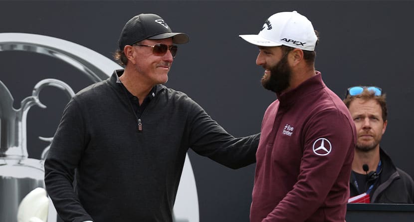 Spain's Jon Rahm, right greets United States' Phil Mickelson on the 1st tee during a practice round for the British Open Golf Championships at the Royal Liverpool Golf Club in Hoylake, England, Wednesday, July 19, 2023. The Open starts Thursday, July 20. Rahm has been saying that he plays golf for history and for legacy, not for money. And now he's playing for the Saudi-funded LIV Golf League in a shocking departure from the PGA Tour. (AP Photo/Peter Morrison, File)