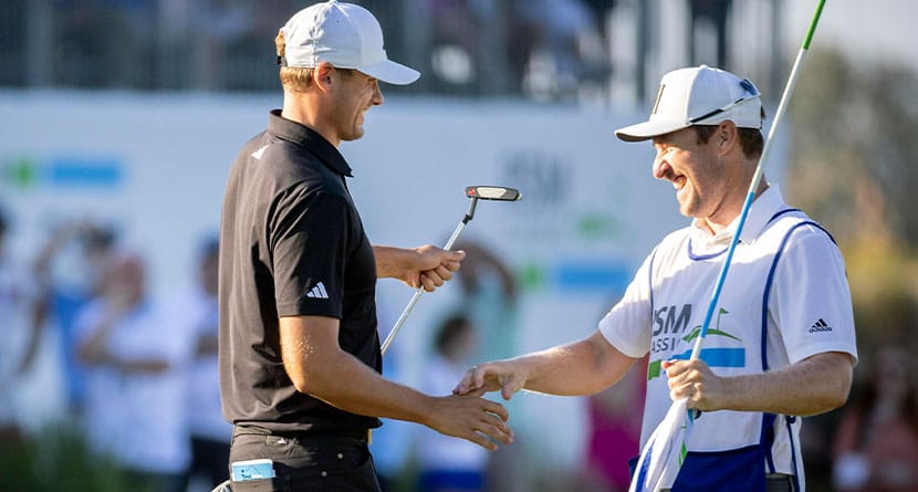 Ludvig Åberg, of Sweden,, left, shakes hand with his caddie after his putt on the 18th green during the final round of the RSM Classic golf tournament, Sunday, Nov. 19, 2023, in St. Simons Island, Ga. (AP Photo/Stephen B. Morton)
