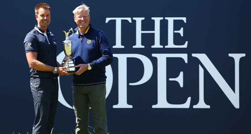 Defending champion Henrik Stenson of Sweden, left, hands over the Claret Jug to Martin Slumbers, Chief Executive of the R&A, during the second practice day at the British Open Golf Championship at Royal Birkdale in Southport, England, Monday, July 17, 2017. (AP Photo/Dave Thompson)