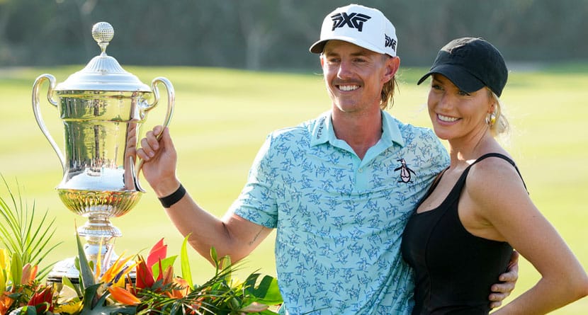 Jake Knapp, of the United States, and his girlfriend Makena White pose with his trophy during the award ceremony after winning the Mexico Open golf tournament in Puerto Vallarta, Mexico, Sunday, Feb. 25, 2024.