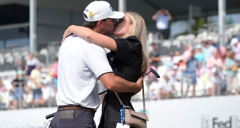 Austin Eckroat kisses his wife Sally after winning the Cognizant Classic golf tournament, Monday, March 4, 2024, in Palm Beach Gardens, Fla. Eckroat got the first victory of his tour career Monday, topping Erik van Rooyen and Min Woo Lee by three shots to win the weather-delayed Cognizant Classic. (AP Photo/Marta Lavandier)