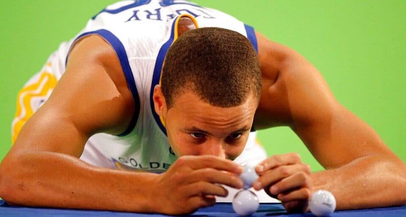 Golden State Warriors' Stephen Curry tries to stack golf balls during the NBA basketball team's media day in Oakland, Calif., Monday, Sept. 27, 2010. (AP Photo/Marcio Jose Sanchez)