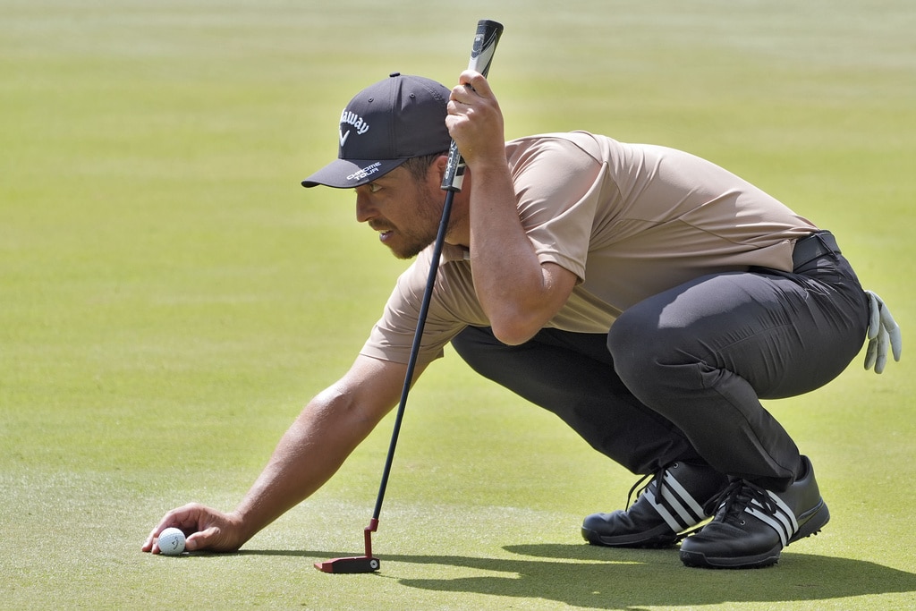 Xander Schauffele lines up his putt on the second hole during the final round of The Players Championship golf tournament Sunday, March 17, 2024, in Ponte Vedra Beach, Fla. (AP Photo/Marta Lavandier)