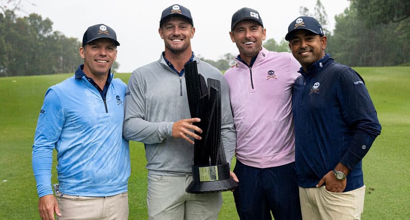 First place Team Champions, Paul Casey, Bryson Dechambeau, Charles Howell III and Anirban Lahiri of Crushers GC pose with the Event Team Champion Trophy after the final round of LIV Golf Hong Kong at the Hong Kong Golf Club in Hong Kong Sunday, March 10, 2024. (Montana Pritchard/LIV Golf via AP)