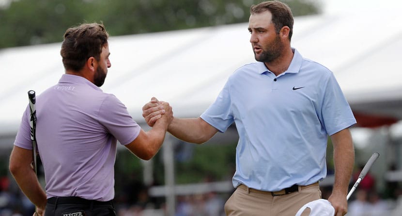 Stephan Jaeger, left, and Scottie Scheffler shake hands after finishing their round on the 18th green during the final round of the Houston Open golf tournament Sunday, March 31, 2024, in Houston.(AP Photo/Michael Wyke)