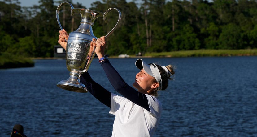 Nelly Korda holds up the trophy while celebrating her win at the Chevron Championship LPGA golf tournament Sunday, April 21, 2024, at The Club at Carlton Woods in The Woodlands, Texas. (AP Photo/David J. Phillip)