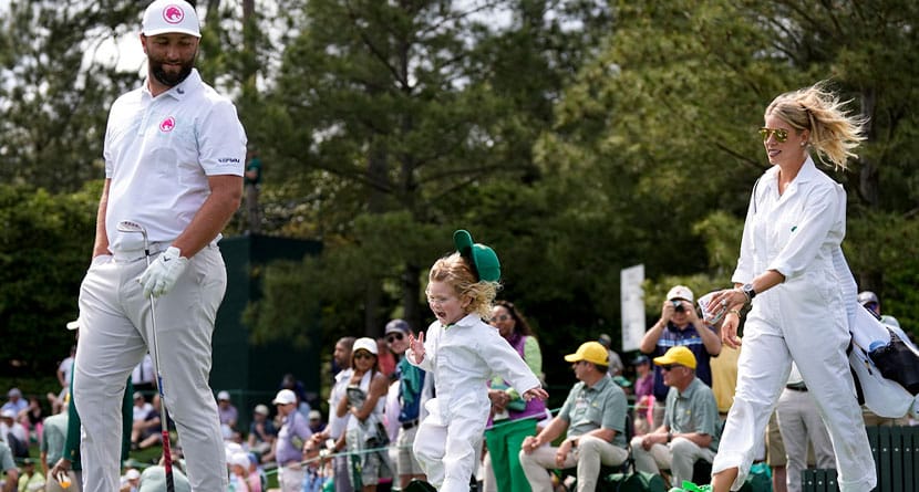 Jon Rahm, of Spain, walks with his wife, Kelley Cahill, and son, Kepa, on the third hole during the par-3 contest at the Masters golf tournament at Augusta National Golf Club Wednesday, April 10, 2024, in Augusta, GA. (AP Photo/George Walker IV)