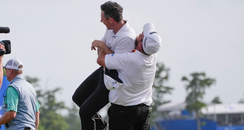Shane Lowry, of Ireland, hoists up teammate Rory McIlroy, of Northern Ireland, after they won the PGA Zurich Classic golf tournament at TPC Louisiana in Avondale, La., Sunday, April 28, 2024. (AP Photo/Gerald Herbert)