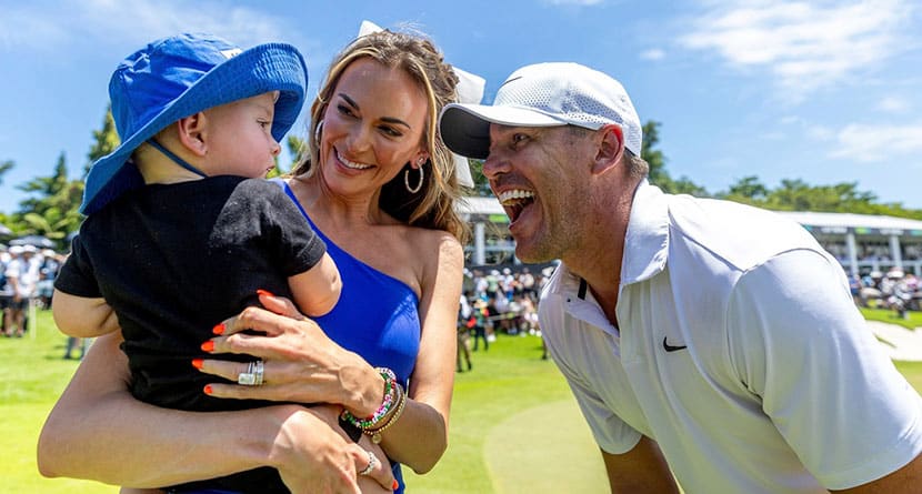 Individual Champion Captain Brooks Koepka of Smash GC celebrate his win with his wife Jena Sims and son Crew on the 18th green after the final round of LIV Golf Singapore at Sentosa Golf Club on Sunday, May 05, 2024 in Sentosa, Singapore. (Photo by Jon Ferrey/LIV Golf via AP)