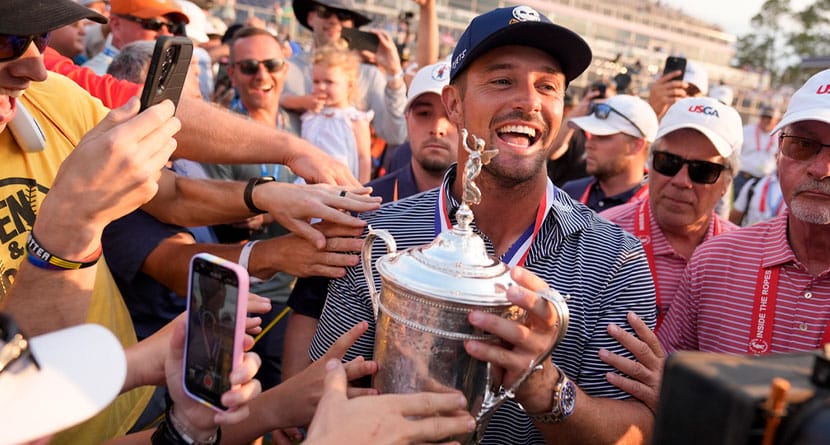 Bryson DeChambeau celebrates with fans and the trophy after winning the U.S. Open golf tournament Sunday, June 16, 2024, in Pinehurst, N.C. (AP Photo/Frank Franklin II)