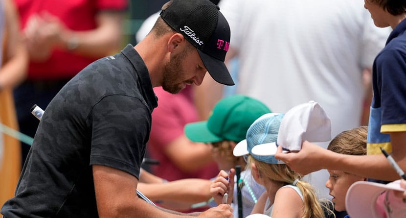 Wyndham Clark signs autographs on the 11th hole during a practice round for the U.S. Open golf tournament Monday, June 10, 2024, in Pinehurst, N.C. (AP Photo/Matt York)