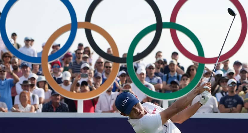 Collin Morikawa, of the United States, plays his shot from the first tee during the second round of the men's golf event at the 2024 Summer Olympics, Friday, Aug. 2, 2024, at Le Golf National in Saint-Quentin-en-Yvelines, France. (AP Photo/Matt York)