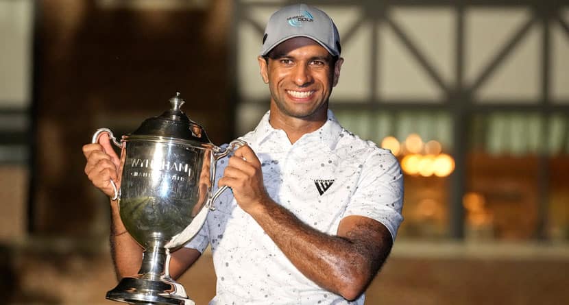 Aaron Rai, of England, poses with the trophy after winning the Wyndham Championship golf tournament in Greensboro, N.C., Sunday, Aug. 11, 2024. (AP Photo/Chuck Burton)