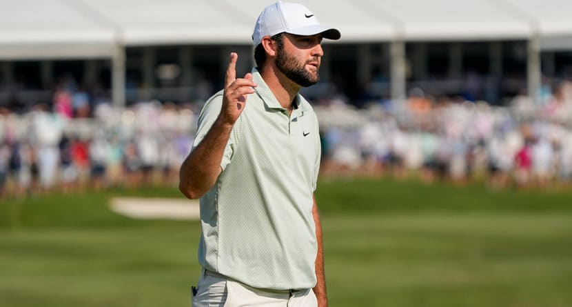 Scottie Scheffler waves after making a putt on the 18th green during the final round of the St. Jude Championship golf tournament Sunday, Aug. 18, 2024, in Memphis, Tenn. (AP Photo/Mark Humphrey)