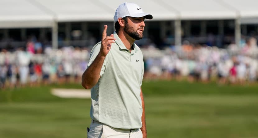 Scottie Scheffler waves after making a putt on the 18th green during the final round of the St. Jude Championship golf tournament Sunday, Aug. 18, 2024, in Memphis, Tenn. (AP Photo/Mark Humphrey)