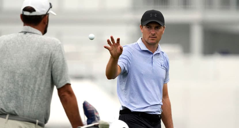 Jordan Spieth, right, catches a ball tossed to him on the driving range at the St. Jude Championship golf tournament Wednesday, Aug. 14, 2024, in Memphis, Tenn. The tournament is scheduled to begin Thursday. (AP Photo/Mark Humphrey)