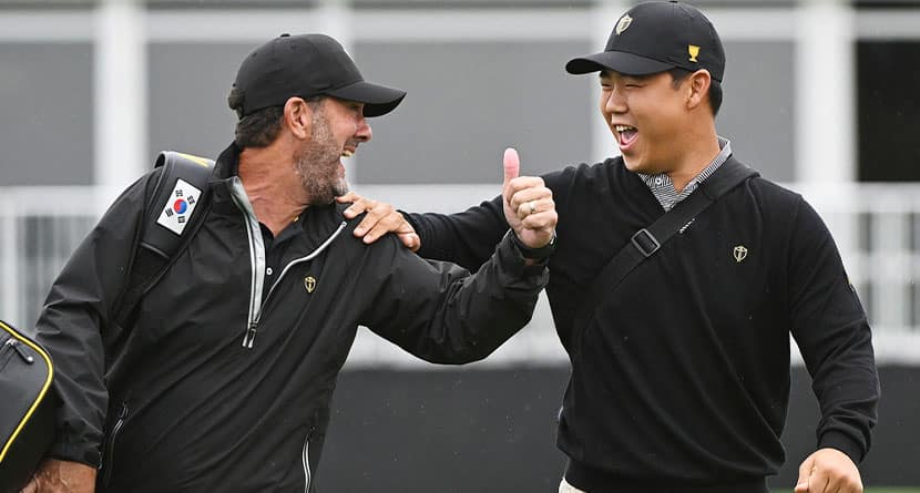 International team member Tom Kim, of South Korea, right, jokes around his caddie Paul Tesori during practice at the Presidents Cup at the Presidents Cup golf tournament, Monday, Sept. 23, 2024, in Montreal. (Graham Hughes/The Canadian Press via AP)