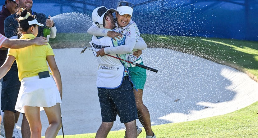 Jasmine Suwannapura, of Thailand, celebrates with her caddie and husband Mike Thomas after winning the LPGA Walmart NW Arkansas Championship golf tournament, Sunday, Sept. 29, 2024, in Rogers, Ark. (AP Photo/Michael Woods)