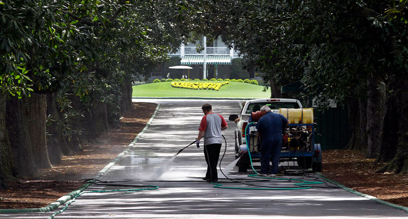 Workers pressure wash Magnolia Lane leading to the clubhouse at the Augusta National Golf Club, the site of the Masters golf tournament, Saturday, April 3, 2010, in Augusta, Ga. The tournament begins Thursday, April, 8, 2010. (AP Photo/Rob Carr)