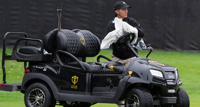 International team captain Mike Weir wipes rain from his golf cart as he attends practice at the Presidents Cup golf tournament at the Presidents Cup golf tournament, Monday, Sept. 23, 2024, in Montreal. (Christinne Muschi/The Canadian Press via AP)