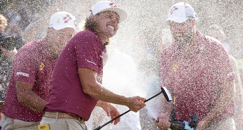 Marc Leishman, right, of Ripper GC, and Lucas Herbert, left, also of Ripper GC, spray captain Cameron Smith, center, also of Ripper GC, on the 18th green after Ripper GC won the final round of LIV Golf Team Championship Dallas at Maridoe Golf Club, Sunday, Sept. 22, 2024, in Carrollton, Texas. (Katelyn Mulcahy/LIV Golf via AP)