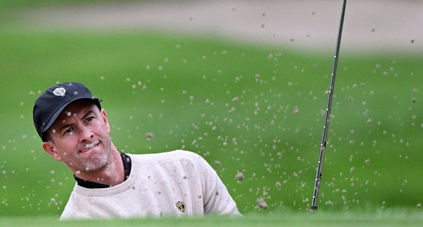 International team member Adam Scott, of Australia, plays a shot from a bunker during a practice round at the Presidents Cup golf tournament at Royal Montreal Golf Club in Montreal, Tuesday, Sept. 24, 2024. (Graham Hughes/The Canadian Press via AP)