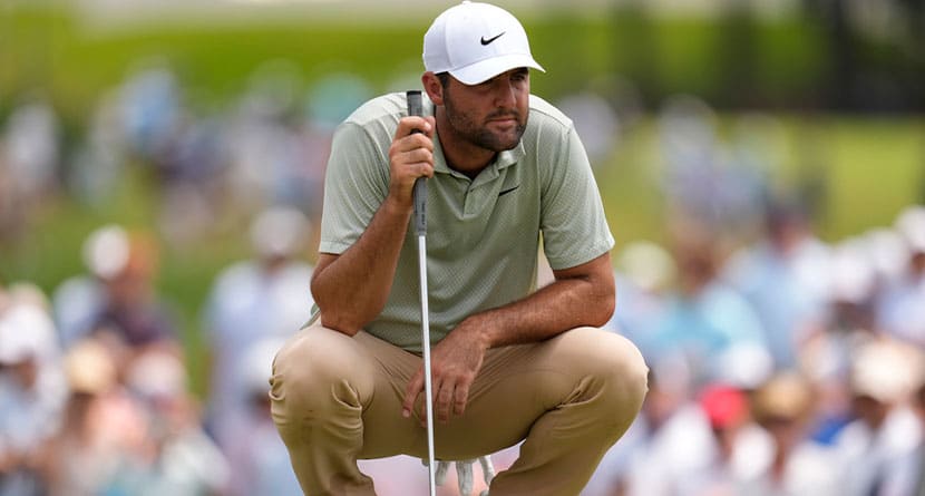 Scottie Scheffler lines up a putt on the third green during the final round of the Tour Championship golf tournament, Sunday, Sept. 1, 2024, in Atlanta. (AP Photo/Mike Stewart)