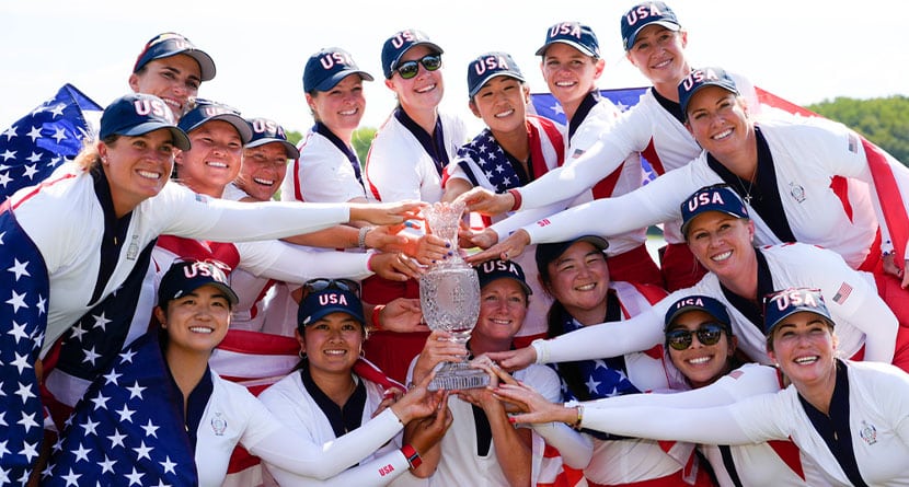 United States players poses for photographs after the United States won the Solheim Cup golf tournament against Europe at the Robert Trent Jones Golf Club, Sunday, Sept. 15, 2024, in Gainesville, Va. (AP Photo/Matt York)