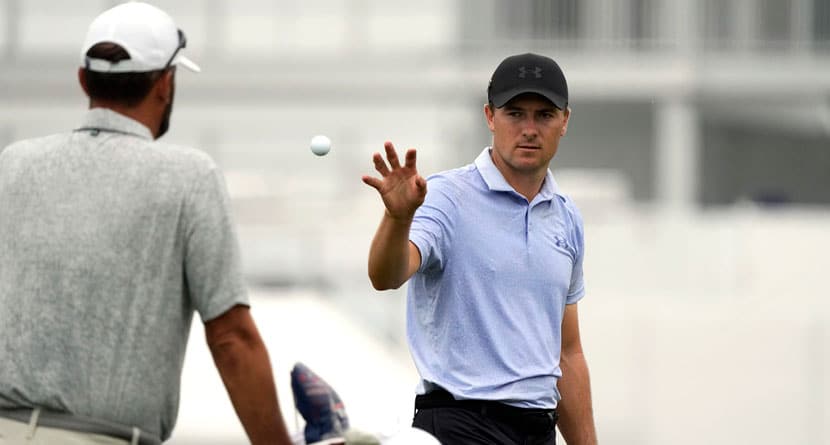 Jordan Spieth, right, catches a ball tossed to him on the driving range at the St. Jude Championship golf tournament Wednesday, Aug. 14, 2024, in Memphis, Tenn. The tournament is scheduled to begin Thursday. (AP Photo/Mark Humphrey)