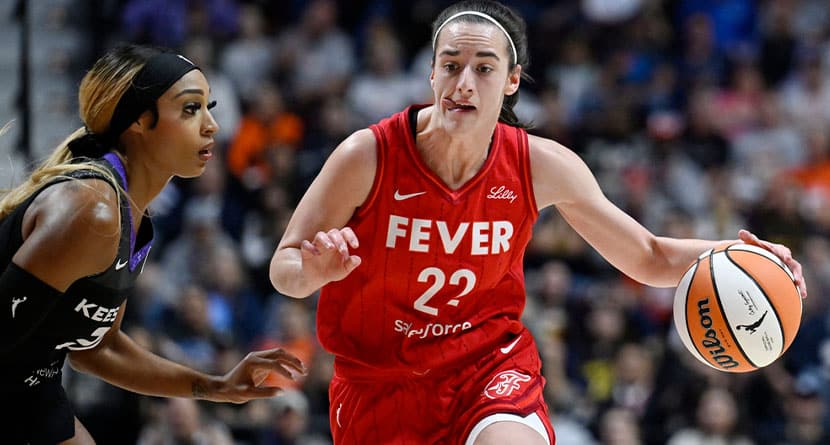 Indiana Fever guard Caitlin Clark (22) drives to the basket as Connecticut Sun guard DiJonai Carrington defends during a first-round WNBA basketball playoff game, Wednesday, Sept. 25, 2024, in Uncasville, Conn. (AP Photo/Jessica Hill)