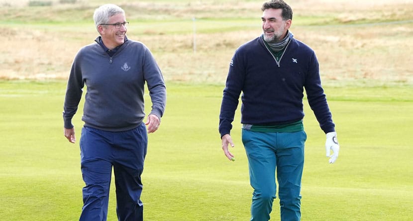 Jay Monahan, left, and Yasir Al Rumayyan walk together on the 11th on day one of the Alfred Dunhill Links Championship at Carnoustie, Angus, Scotland, Thursday Oct. 3, 2024. (Jane Barlow/PA via AP)