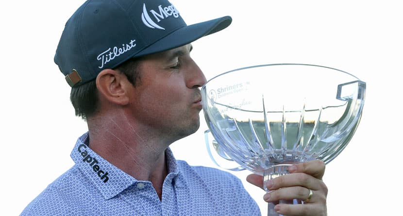 J.T. Poston kisses the trophy after winning the Shriners Children's Open golf tournament, Sunday, Oct. 20, 2024, in Las Vegas. (AP Photo/Ian Maule)