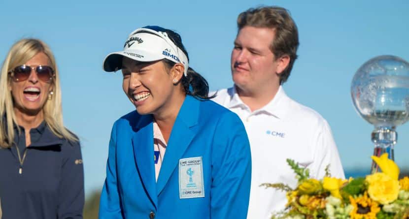 Jeeno Thitikul, center, reacts on the 18th green after putting on the blue jacket after winning the LPGA CME Group Tour Championship golf tournament Sunday, Nov. 24, 2024, in Naples, Fla. (AP Photo/Chris Tilley)