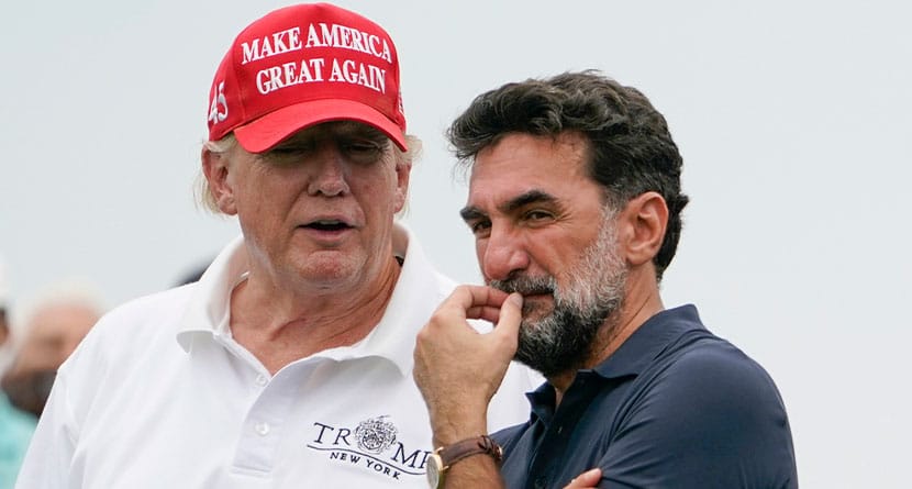 Former President Donald Trump, left, talks with Yasir Al-Rumayyan, governor of Saudi Arabia's Public Investment Fund, on the 16th hole during the first round of the Bedminster Invitational LIV Golf tournament in Bedminster, NJ., July 29, 2022. (AP Photo/Seth Wenig, File)