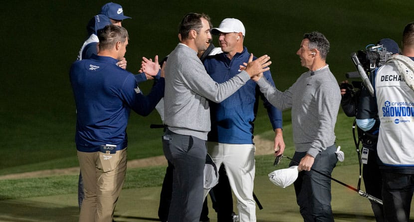 Captain Bryson DeChambeau of Crushers GC high fives Captain Brooks Koepka of Smash GC, and Scottie Scheffler high fives Rory McIlroy on the 16th green during the Showdown at the Shadow Creek Golf Course on Tuesday, Dec. 17, 2024 in Las Vegas, Nevada. (Photo by Montana Pritchard/LIV Golf)