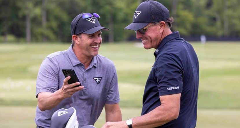 Caddie Tim Mickelson and Captain Phil Mickelson of HyFlyers GC laugh on the driving range before the final round of LIV Golf DC at the Trump National Golf Club Washington DC on Sunday, May 28, 2023 in Sterling, Virginia. (Photo by LIV Golf via AP)