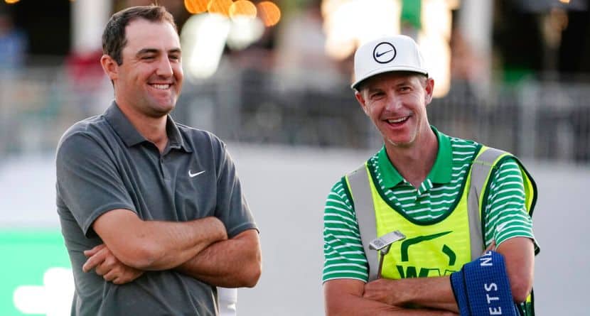 Scottie Scheffler shares a laugh with his caddy after his round during the third round of the Phoenix Open golf tournament, Saturday, Feb. 11, 2023, in Scottsdale, Ariz. Scheffler leads the tournament at 13 under par. (AP Photo/Darryl Webb)