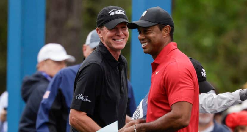 Tiger Woods, right, and Steve Stricker, left, laugh before teeing off during the final round of the PNC Championship golf tournament Sunday, Dec. 17, 2023, in Orlando, Fla. (AP Photo/Kevin Kolczynski)