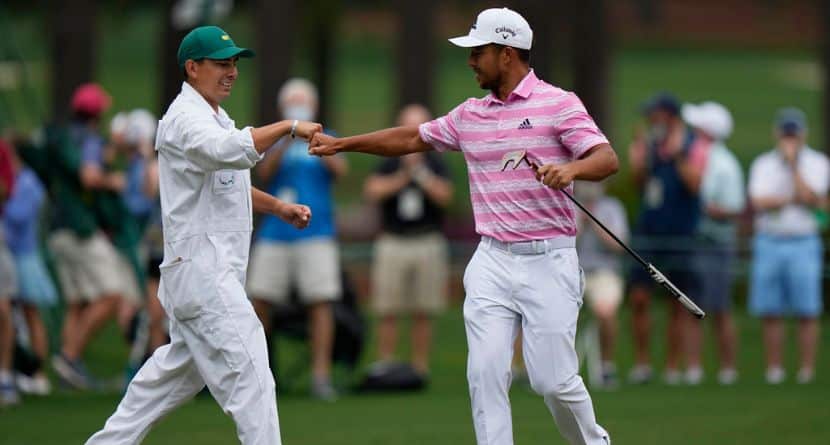 Xander Schauffele is congratulated by his caddie Austin Kaiser after an eagle on the 15th hole during the third round of the Masters golf tournament on Saturday, April 10, 2021, in Augusta, Ga. (AP Photo/Matt Slocum)