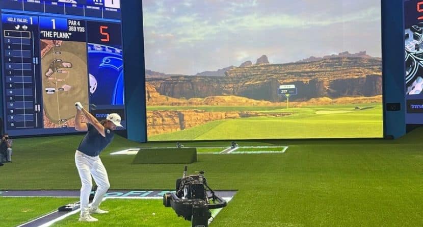 Rickie Fowler hits into the massive simulator screen at the SoFi Center in Palm Beach Gardens, Fla, on Dec. 18, 2024. The 250,000-square-foot complex holds the new TMRW Golf League co-owned by Tiger Woods and Rory McIlroy. The first match is Jan. 7, 2025 in prime time on ESPN. (AP Photo/Doug Ferguson)