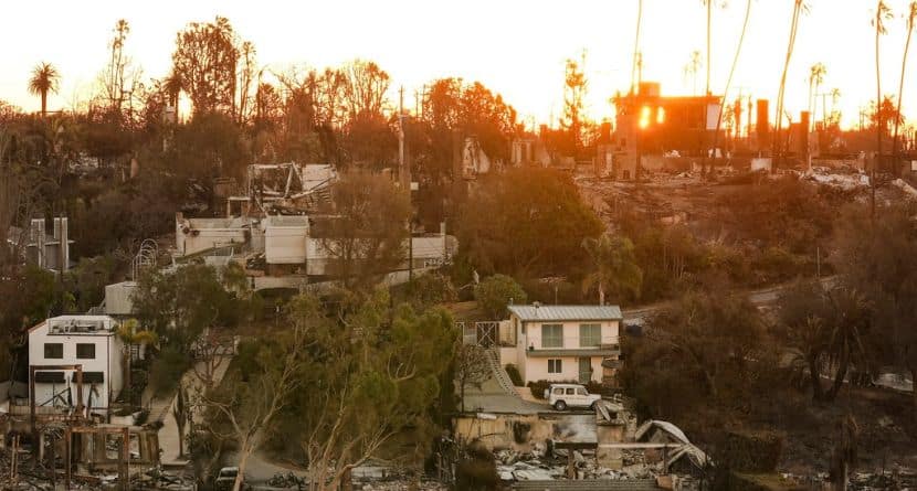 The Sun rises over homes destroyed by the Palisades Fire in the Pacific Palisades neighborhood of Los Angeles, Thursday, Jan. 16, 2025. (AP Photo/Damian Dovarganes)