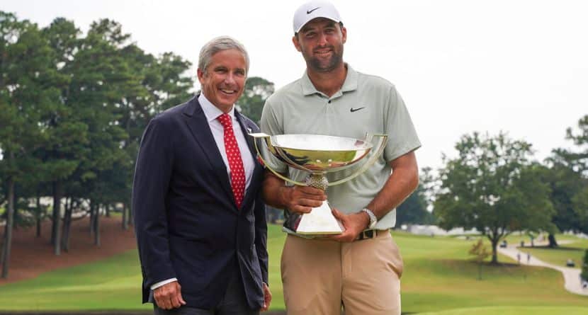 PGA Tour Commissioner Jay Monahan, left, poses with Scottie Scheffler and the FedExCup Trophy after Scheffler won the final round of the Tour Championship golf tournament, Sunday, Sept. 1, 2024, in Atlanta. (AP Photo/Jason Allen)