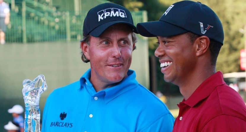 Phil Mickelson, left, and Tiger Woods pose with their trophies after the final round of The Tour Championship golf tournament at East Lake Golf Club in Atlanta Sunday, Sept. 27, 2009. Mickelson won The Tour Championship and Tiger Woods won the FedEx Cup. (AP Photo/Dave Martin)