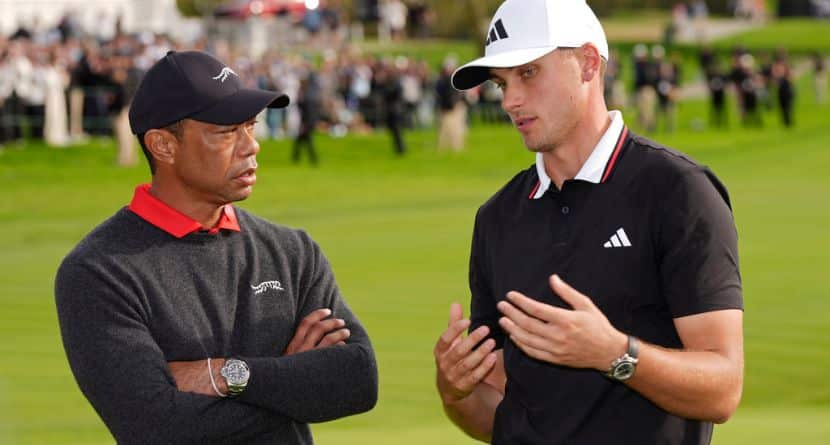 Ludvig Åberg, of Sweden, right, speaks with Tiger Woods after winning the Genesis Invitational golf tournament Sunday, Feb. 16, 2025, in San Diego. (AP Photo/Gregory Bull)