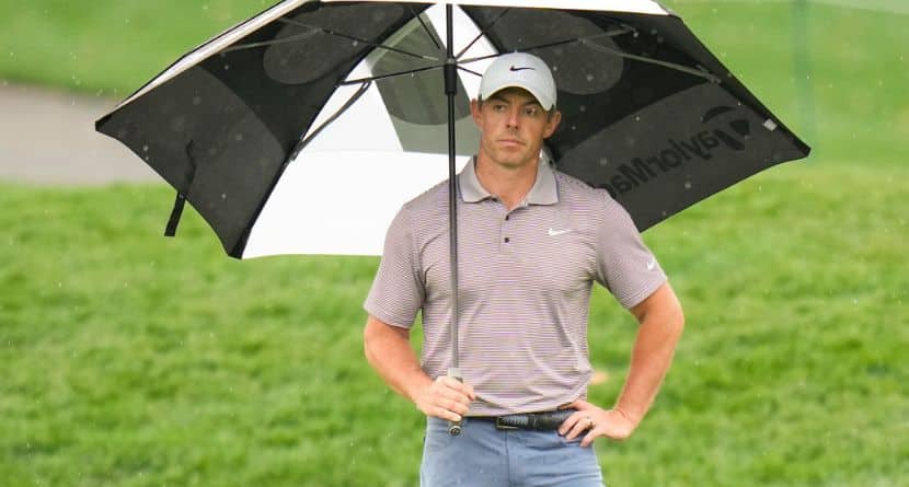 Rory McIlroy, of Northern Ireland, holds an umbrella on the 11th green during the final round of The Players Championship golf tournament Sunday, March 16, 2025, in Ponte Vedra Beach, Fla. (AP Photo/Chris O'Meara)