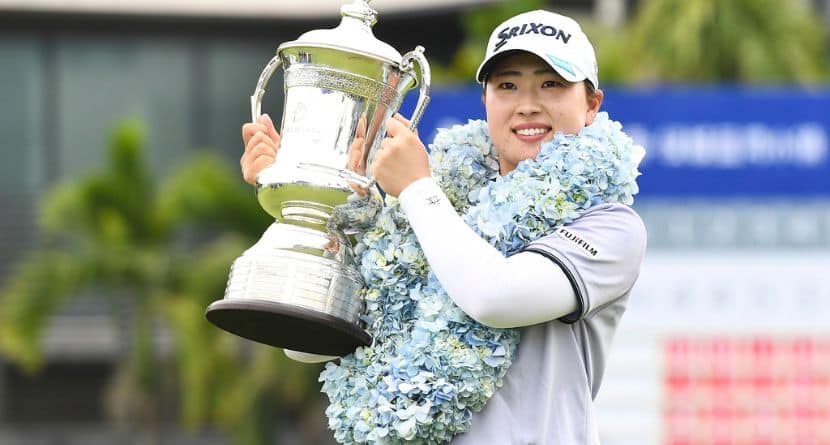 In this photo released by Xinhua News Agency, winner Takeda Rio of Japan holds the trophy during the awarding ceremony after the fourth round of the Blue Bay LPGA golf tournament in Lingshui, south China's Hainan Province, Sunday March 9, 2025. (Yang Guanyu/Xinhua via AP)