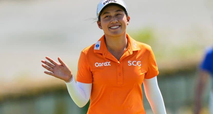 Jeeno Thitikul, of Thailand, waves as she arrives on the 18th green during the final round of the Mizuho Americas Open LPGA golf tournament, Sunday, May 11, 2025, in Jersey City, N.J. (AP Photo/Seth Wenig)