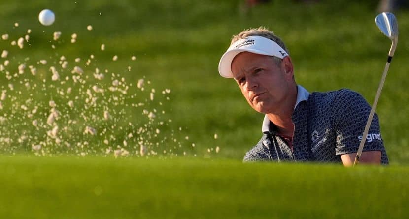 Luke Donald, of England, hits from the bunker on the first hole during the first round of the PGA Championship golf tournament at the Quail Hollow Club, Thursday, May 15, 2025, in Charlotte, N.C. (AP Photo/George Walker IV)